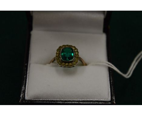 A 9ct gold ring set with central green stone, size M.