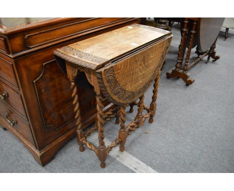 An oak drop-leaf gate-leg barley twist occasional table.