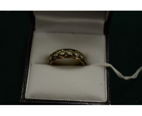 A gold and cubic zirconia ring, size N.