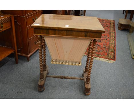 A 19th century rosewood work table with bobbin turned supports.