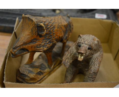 Carved wood model of a boar and a bear.