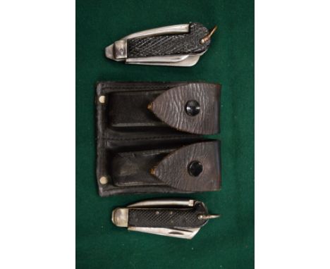 Leather belt pouch containing two army knives.