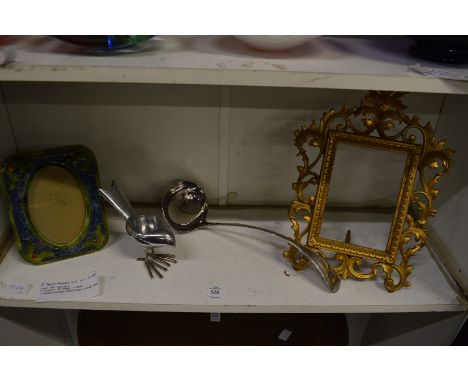 Two decorative photograph frames, a ladle and tea light holder modelled as a bird.