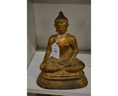 A gilt bronze model of a seated Buddha.