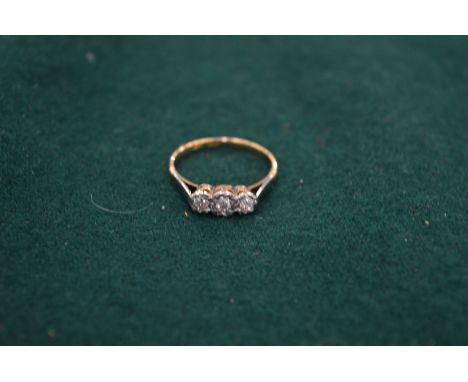 An 18ct gold and platinum diamond three stone ring, size R.