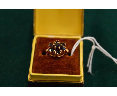 A 9ct gold and garnet cluster ring, size M.