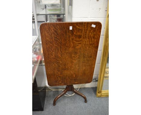 A 19th century oak rectangular tilt-top tripod table.