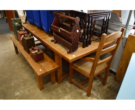 A heavy oak extending dining table with two armchairs, three single chairs and a bench seat.