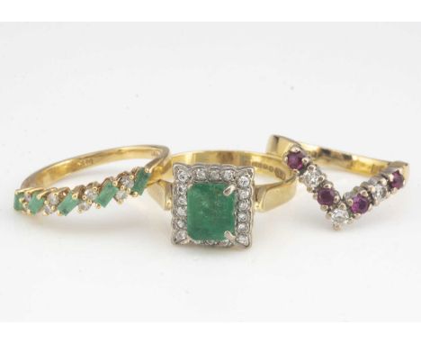 A collection of three gem set dress rings, including an emerald and diamond 18ct gold cluster ring, ring size O, emerald heav