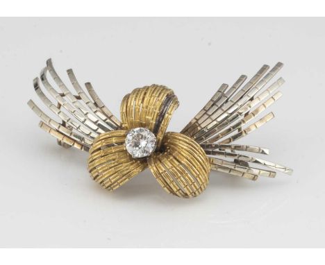 A continental 18ct gold two colour gold diamond bow brooch, centred with a brilliant cut diamond within a three petal mount a