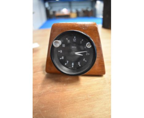A mid century mahogany cased Smiths automobile clock.