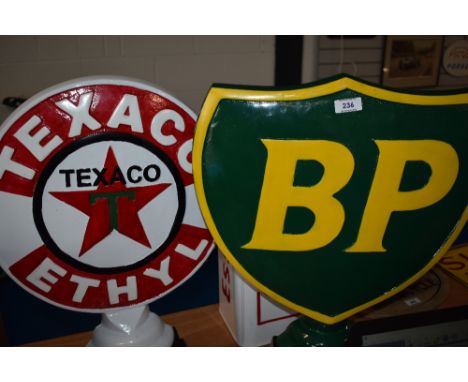 A reproduction BP sign and a Texaco sign.