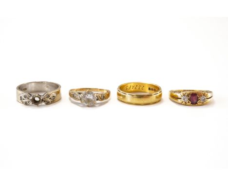 FOUR GOLD RINGS (4)To include a ruby and diamond three stone ring, in unmarked gold, size K, weight 4 grams, a 4.5mm band in 