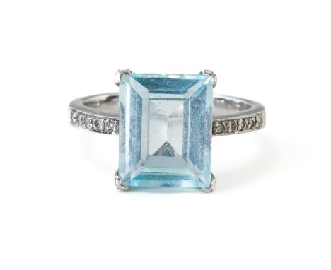 A TOPAZ RING (2)Claw set with a central baguette cut topaz measuring 11.02mm x 8.99mm, with single cut diamond set to the sho