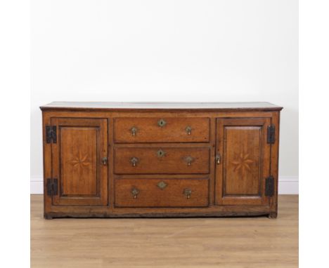 A GEORGE III OAK DRESSER BASEWith three central drawers flanked by cupboards, 177cm wide; 56cm deep; 83cm highOld marks and s
