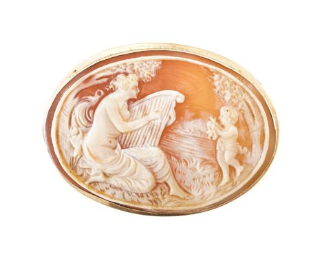 A LARGE OVAL SHELL CAMEO BROOCHDepicting a woman playing the harp with a cherub, in an 18ct frame, gross weight 12.59 grams