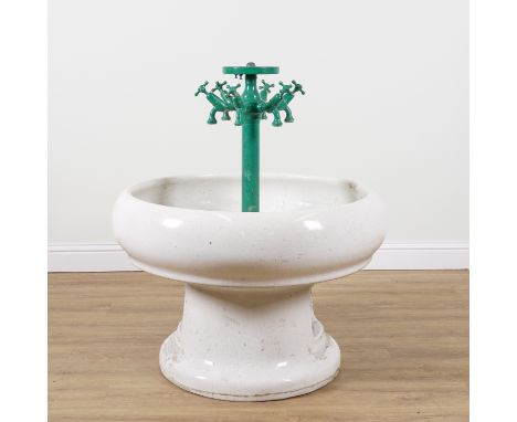 A SIX TAP COMMUNAL WASH BASINWith circular ceramic reservoir, 100cm diameter; 105cm high