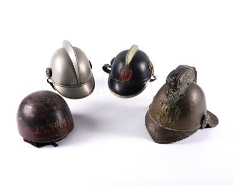 A GROUP OF FOUR VARIOUS HELMETS INCLUDING A VICTORIAN FIREMAN’S HELMET (4)Together with two Austrian fire helmets, one with b