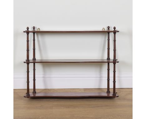 A REGENCY MAHOGANY SERPENTINE THREE TIER HANGING OPEN SHELFWith turned supports, 88cm wide; 20cm deep; 65cm high