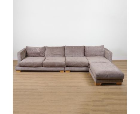 A LARGE GREY UPHOLSTERED TWO SECTION SOFA (2)360cm wide; 70cm high, and a matching footstool on oak block supports, 90cm wide