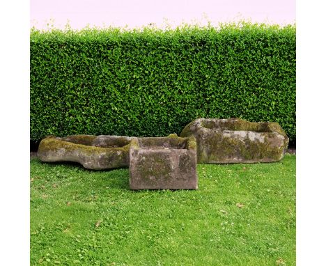 A ROUGHLY HEWN IRREGULAR SHAPED CARVED SANDSTONE TROUGH (3)80cm wide; 47cm deep; 15cm high, a rectangular Cotswold stone trou
