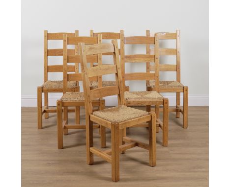 A SET OF SIX OAK FRAMED LADDER BACK DINING CHAIRS (6)With rush seats, 47cm wise; 107cm high