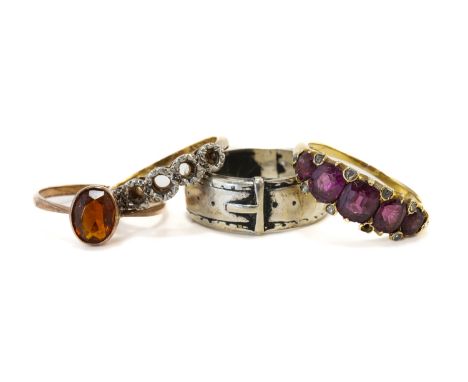 FOUR RINGS (4)Comprising; a gold and garnet ring, mounted with a row of five graduated cushion shaped diamonds, with pairs of