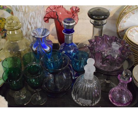 A Tray of Coloured Glassware to Include Cranberry Glass Vase, Smoke Coloured Decanter, Goebel 1979 Glass Bell, Green Glass Sh