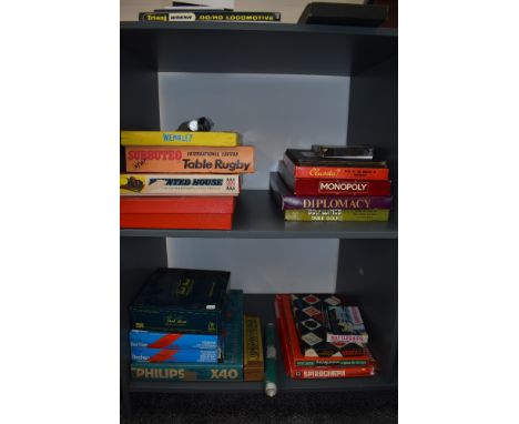 Two shelves of vintage Games including John Waddington Ltd Monopoly, Ariel Game Wembley, Denys Fisher Haunted House, Merit Mo