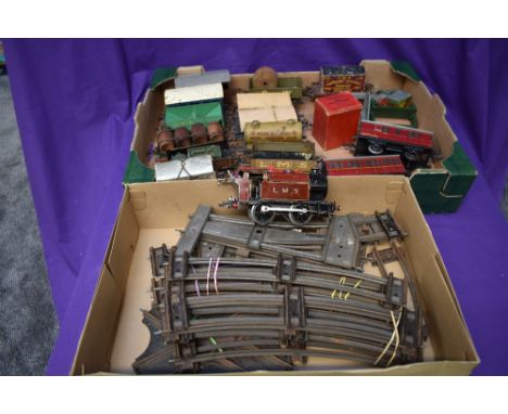 A selection of Hornby 0 gauge including 0-4-0 LMS engine, two carriages, rolling stock, buffer stops and track