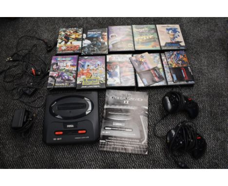 A Sega 16-Bit Mega Drive II Console with two controllers and 10 cartridges, Ultimate Soccer, Sonic The Hedgehog, Power Drive,