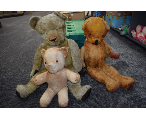 Two mid 20th century straw filed light and dark yellow plush Teddy Bears having replacement eyes, stitched noses and mouths a