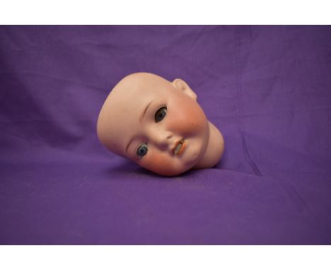 A early 20th century Heubach Koppelsdorf Bisque Head having sleep eyes and open mouth with two teeth showing, numbered 320-4