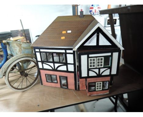 A traditional wooden two storey Dolls House, part furnished along with a 1990's Mattel Sindy style doll, height 55cm, length 