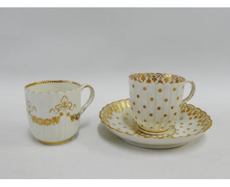 Caughley porcelain cup and saucer with gilt foliage and dot pattern, together with a similar small cup with bow and swag gilt