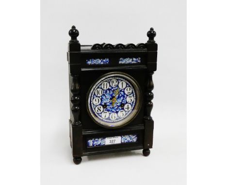 Mantle clock in ebonised wooden case with blue and white floral ceramic pottery dial with Arabic numerals, strikes on a gong,