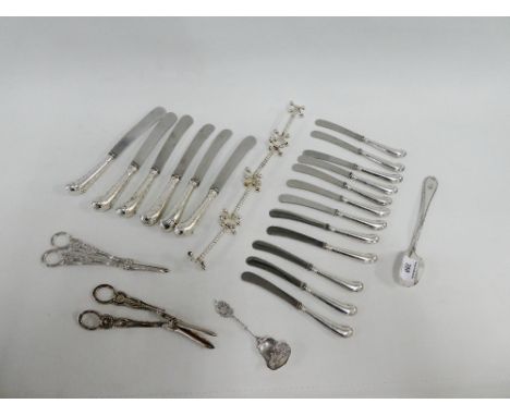 Collection of silver handled butter knives, together with Epns knife rests, spoon and scoop etc., (a lot) 