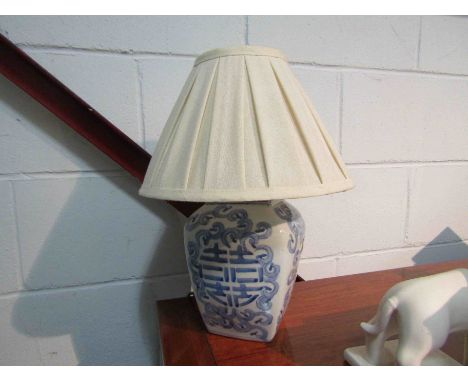 An Oriental blue and white floral design table lamp with pleated shade, 40cm tall