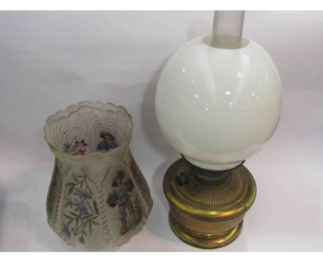 A brass oil lamp with two shades