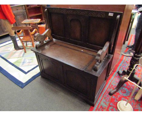 A monks bench with carved lion arms, 97cm tall (open) 95cm x 42cm
