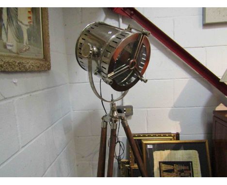An industrial style standard lamp on tripod base