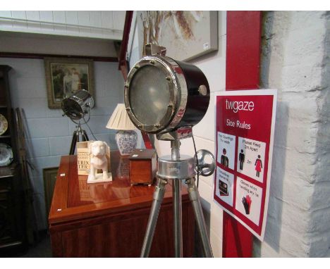 An industrial style standard lamp on tripod base