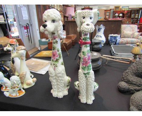 Two ceramic poodle figures with floral decoration, 56cm tall