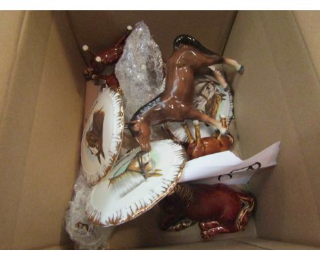 A box containing horse ornaments and plates and three large ceramic horses