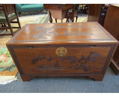 A mid 20th Century Southeast Asia camphor wood trunk with carved decoration and sliding tray (with lock), 101cm x 55cm x 56cm