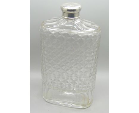 A silver topped glass flask 