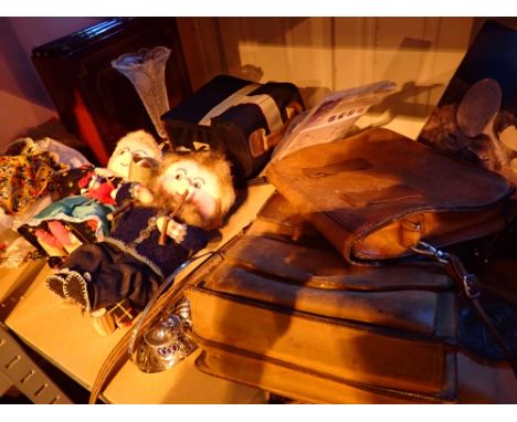 Shelf of mixed items including leather bags and Hungarian dolls