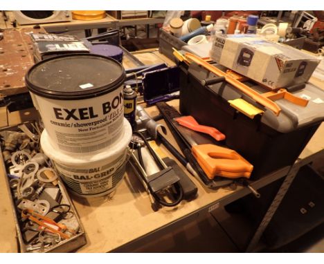 Shelved toolbox with handtools tub of tile adhesive footpump water filters saws etc and an electric jigsaw