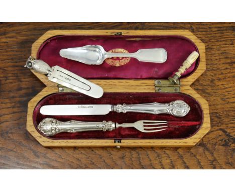 A late Victorian  silver bookmarker with an owl terminal London 1900; a silver caddy spoon; a stamp seal with a train motif; 