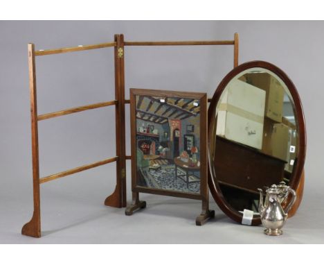 An Edwardian inlaid mahogany frame oval wall mirror inset bevelled plate, 20½” x 32”; together with a mahogany folding towel-